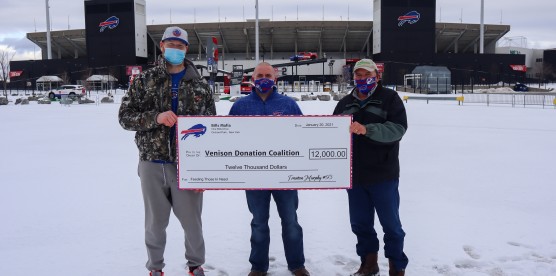 Buffalo Bills Trent Murphy presenting $12,000.00 check to the Venison Donation Coalition